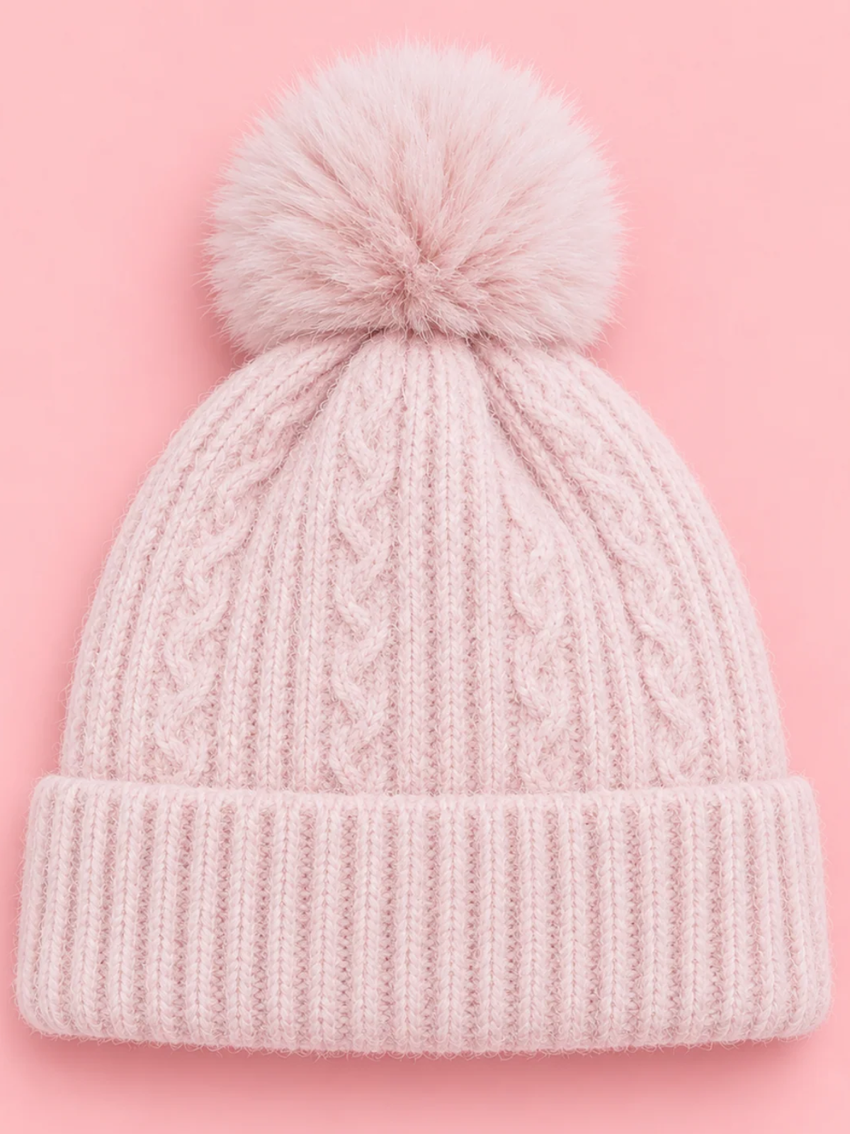 Snow Day Pom Beanie in Pink from Sassy Shortcake, a light pink cable knit beanie with a ribbed fold-over cuff and a fluffy pink pom pom.
