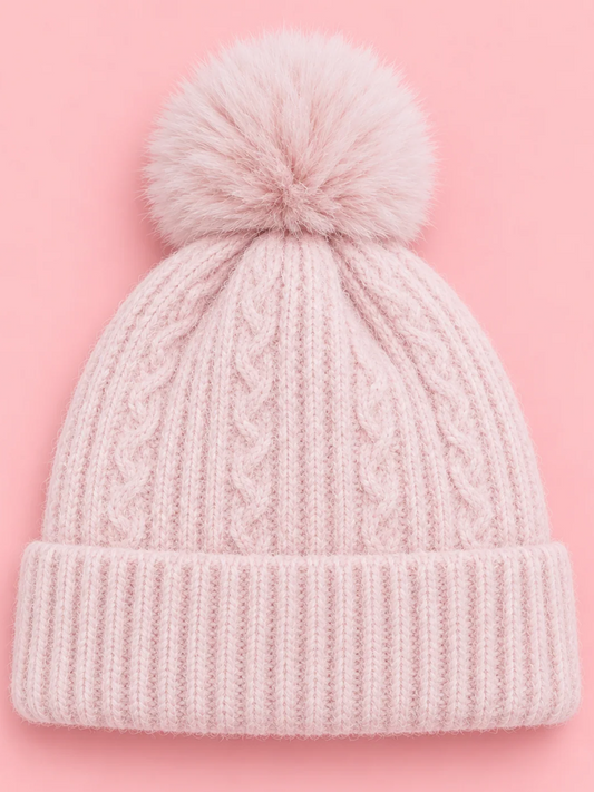 Snow Day Pom Beanie in Pink from Sassy Shortcake, a light pink cable knit beanie with a ribbed fold-over cuff and a fluffy pink pom pom.