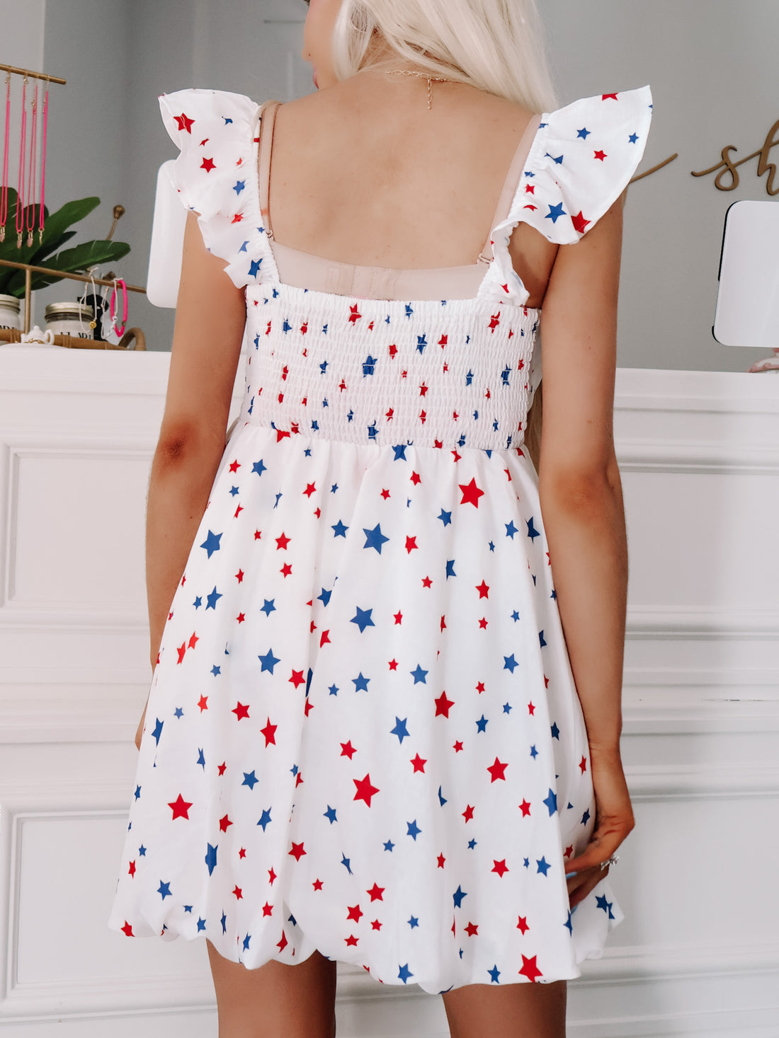Back view of playful star print dress styled for backyard parties and parades.