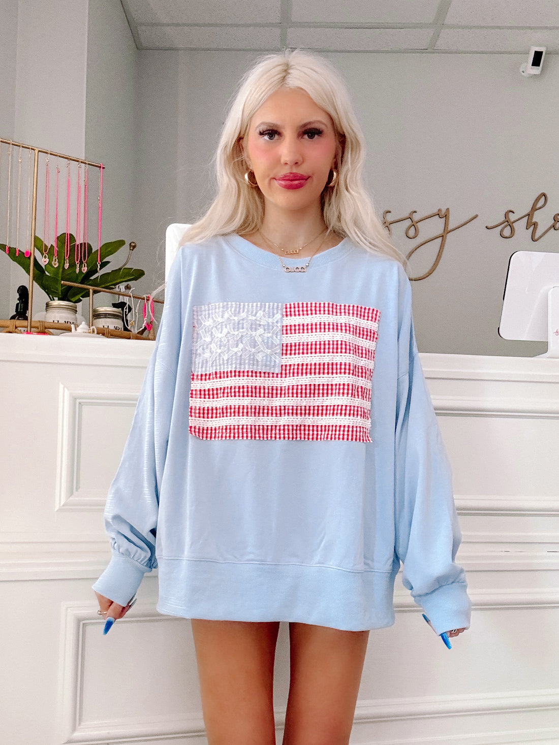Model showing off comfy oversized fit of patriotic blue crewneck.