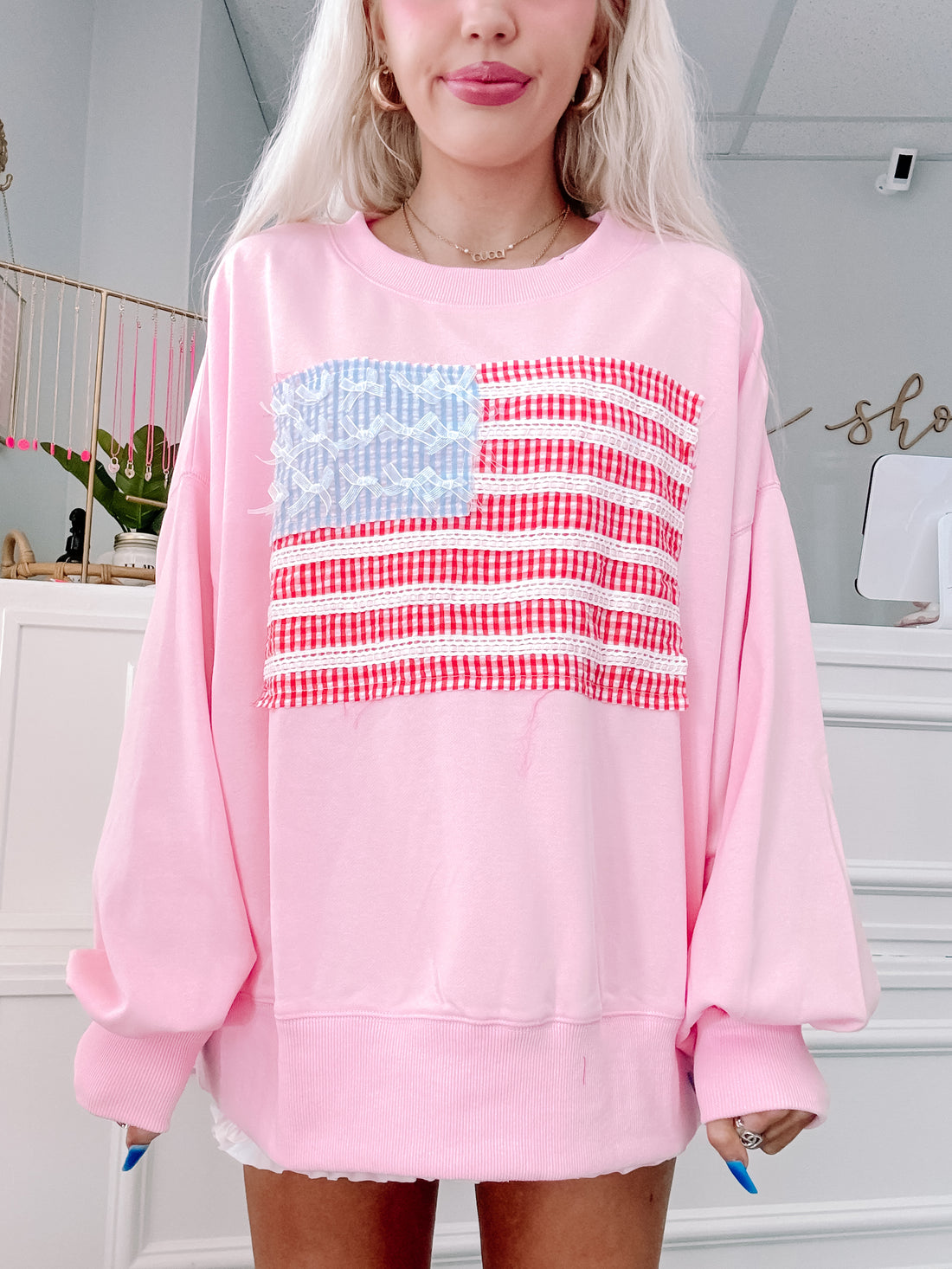 Front view of oversized pink crewneck perfect for festive summer nights.