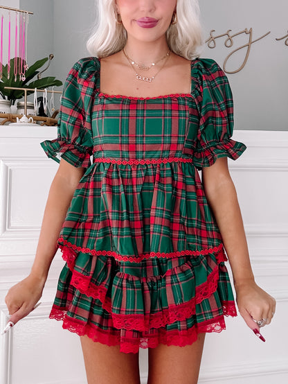 Tinsel Tartan Top: Festive green & red plaid top with ruffled hem & lace trim.
