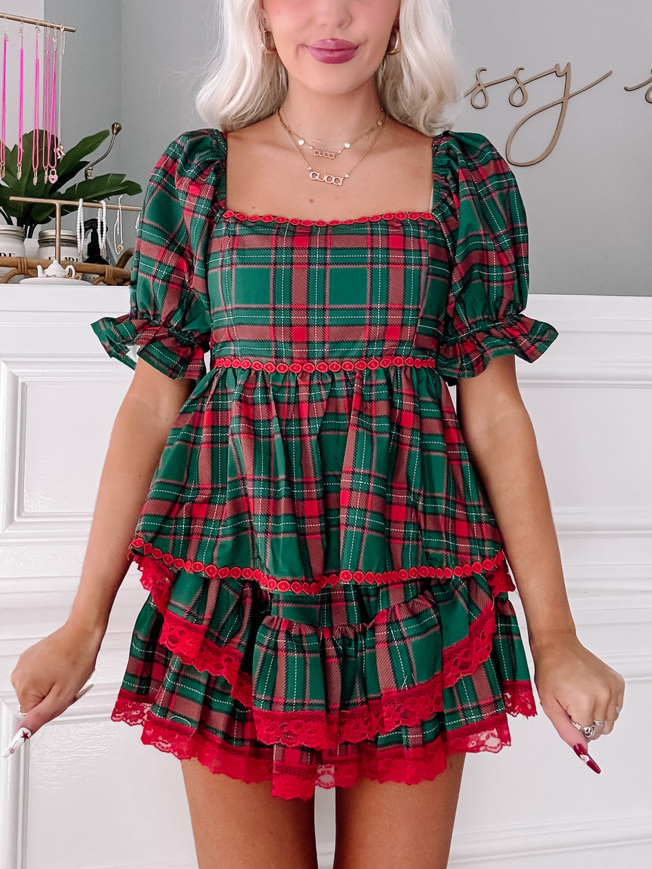 Tinsel Tartan Top: Festive green & red plaid top with ruffled hem & lace trim.
