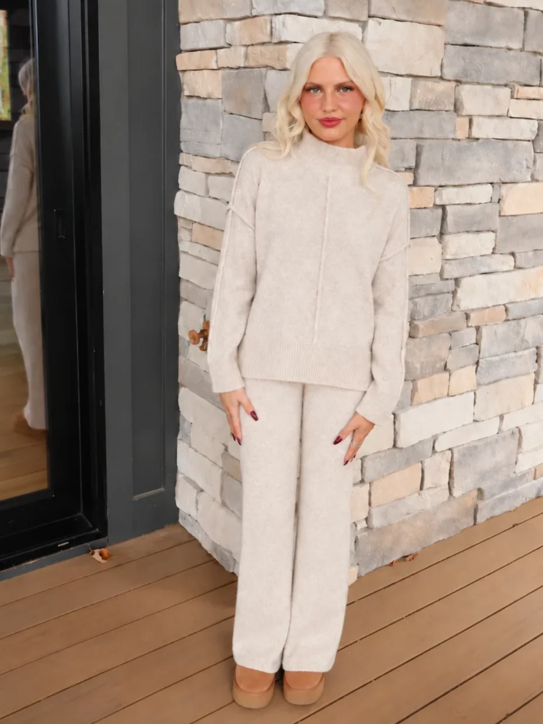 Close-up of the Sassy Shortcake Toasted Almond Knit Set showing the heathered oatmeal knit texture, exposed seams, and ribbed hem with side slits.
