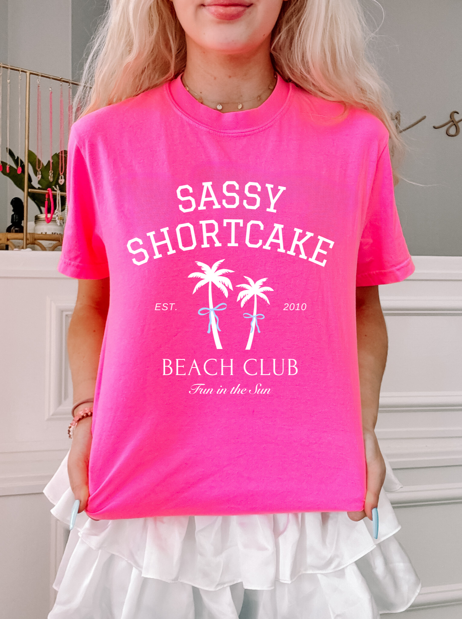 Pink Sassy Shortcake Beach Club Tee, "Fun in the Sun," palm tree graphic.
