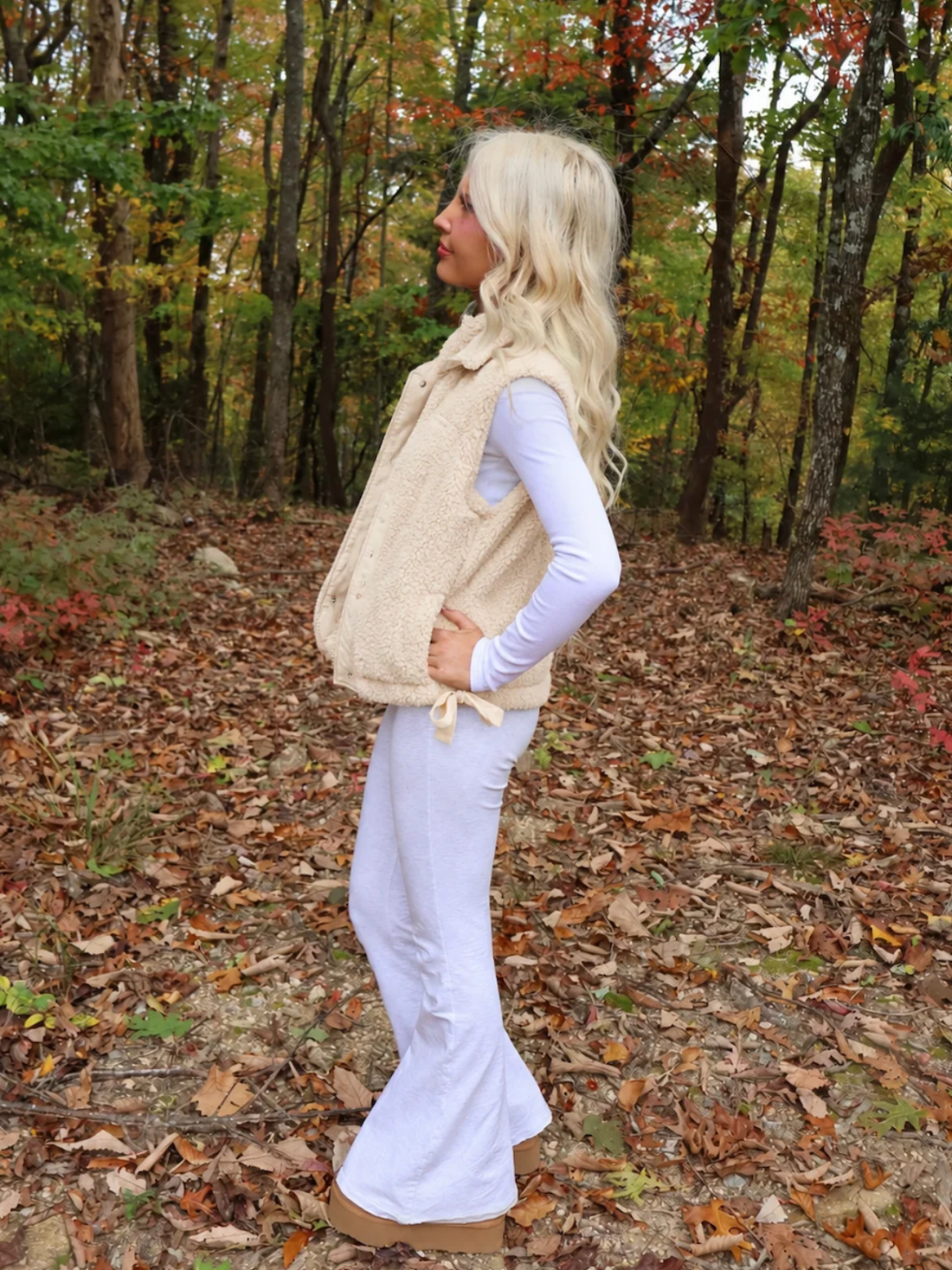 Close-up of the Sassy Shortcake Vanilla Bean Bow Vest showing the soft cream sherpa texture, snap buttons, and bow.
