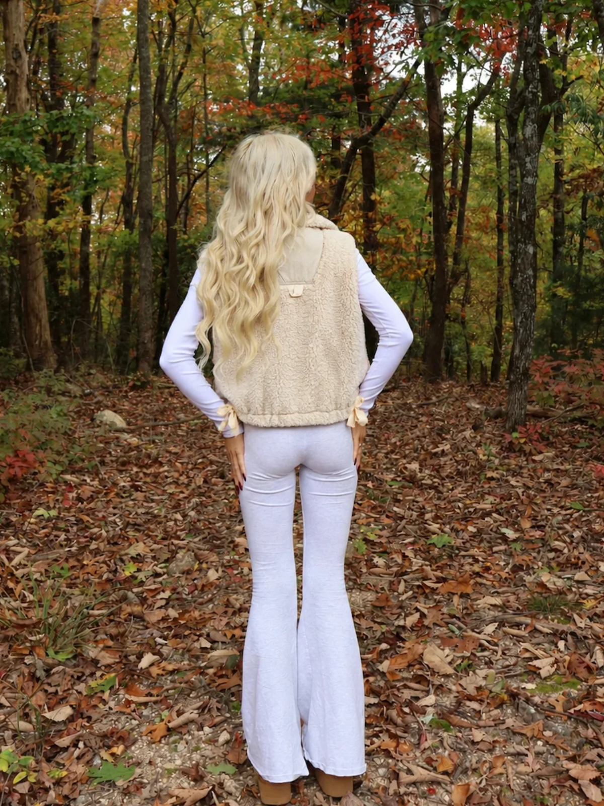 Back view of the Vanilla Bean Bow Vest by Sassy Shortcake showing the cream sherpa fabric and back details.
