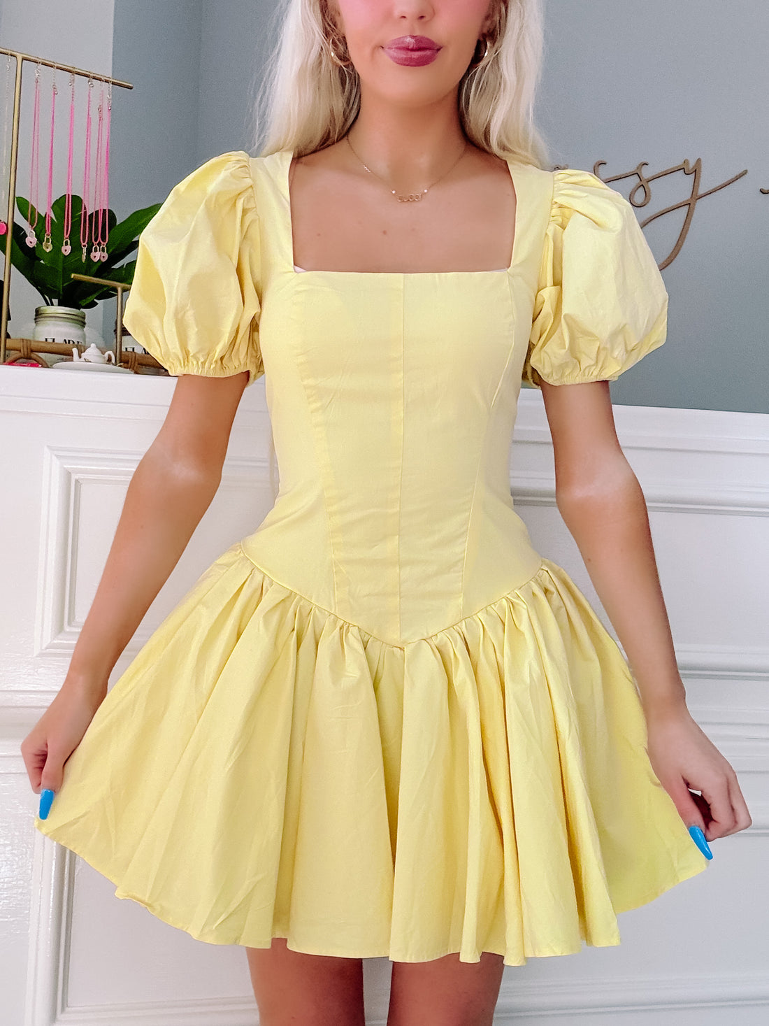 yellow mini dress with puff sleeves and a fitted bodice, shown on a model from Sassy Shortcake Boutique
