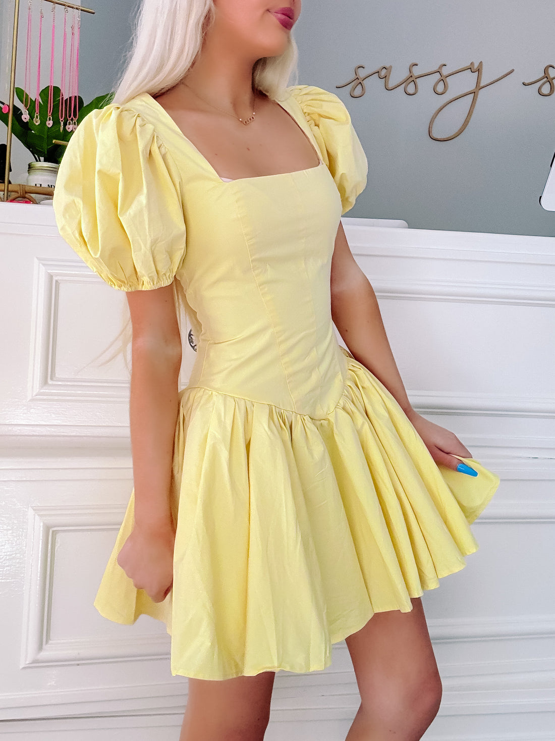 Pale yellow puff-sleeve mini dress, fit-and-flare silhouette, shown on model.

