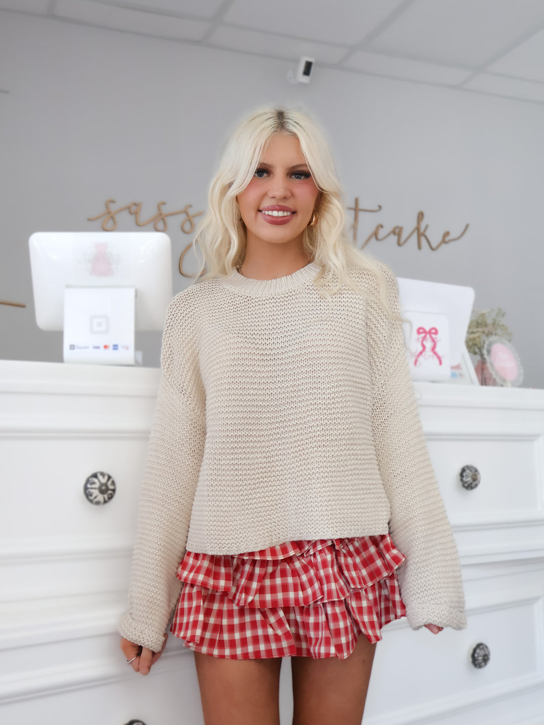 Model wearing the Almond Sweater — soft ivory beige knit pullover with classic cable knit design | Sassy Shortcake