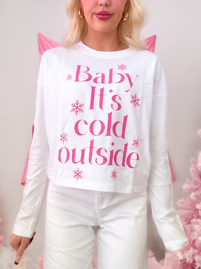 White short-sleeve t-shirt with a seasonal hot pink graphic that reads 'Baby It's Cold Outside,' modeled on figure.