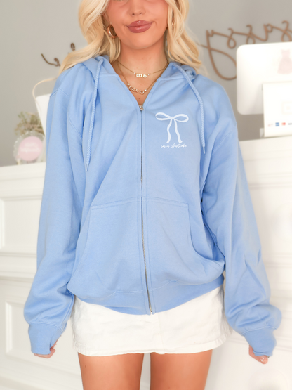 Sassy Shortcake preppy oversized blue zip-up hoodie with white bow graphic and fleece lining.