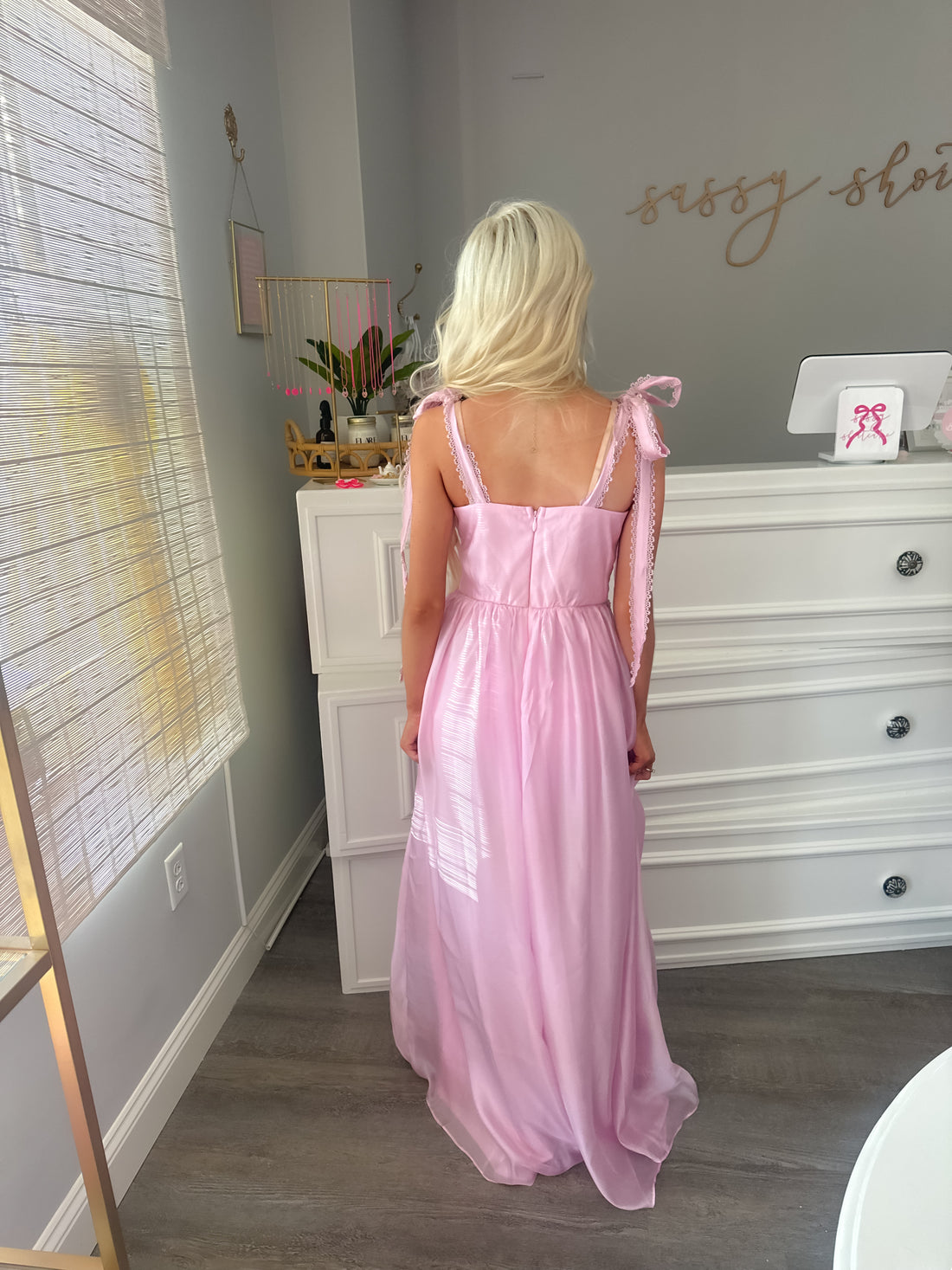 Back view of pink tulle ruffle prom dress showing subtle zipper closure and flowy layered texture