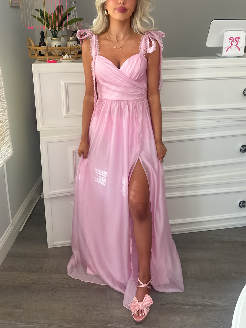 Blush & Bubbly pink strapless tulle dress with layered ruffle skirt, modeled in boutique setting