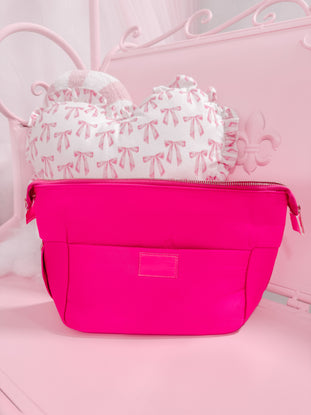 Neon pink Blush Essentials Bag with zipper closure.
