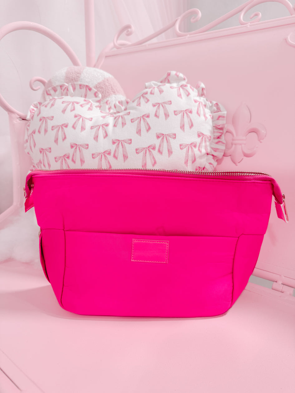 Neon pink Blush Essentials Bag with zipper closure.
