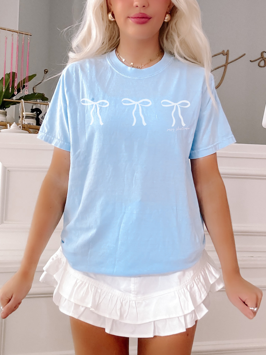 Sassy Shortcake Blushing Bow Tee in sky blue features three white bows.
