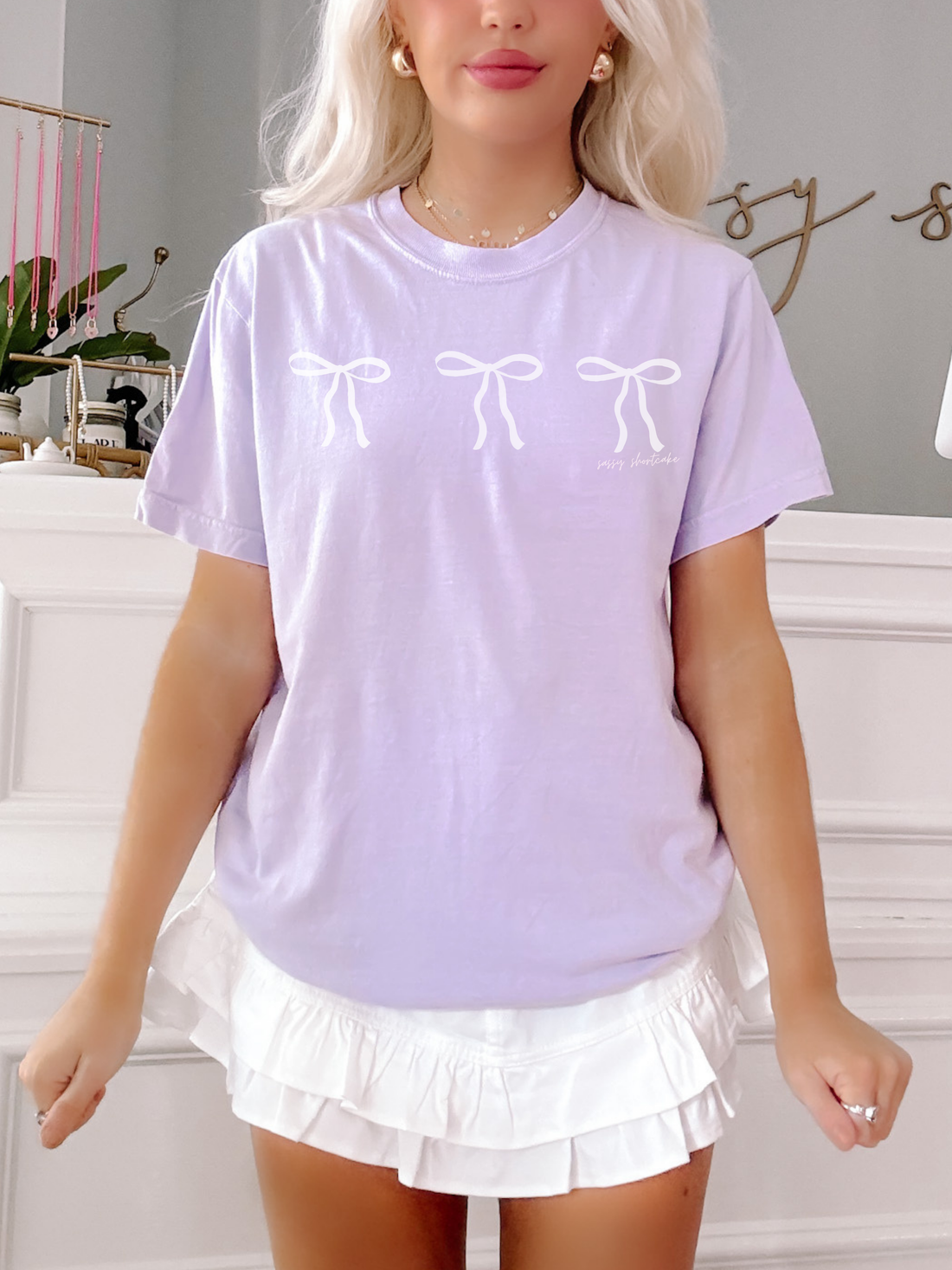 Lilac Blushing Bow Tee by Sassy Shortcake featuring three white bows.
