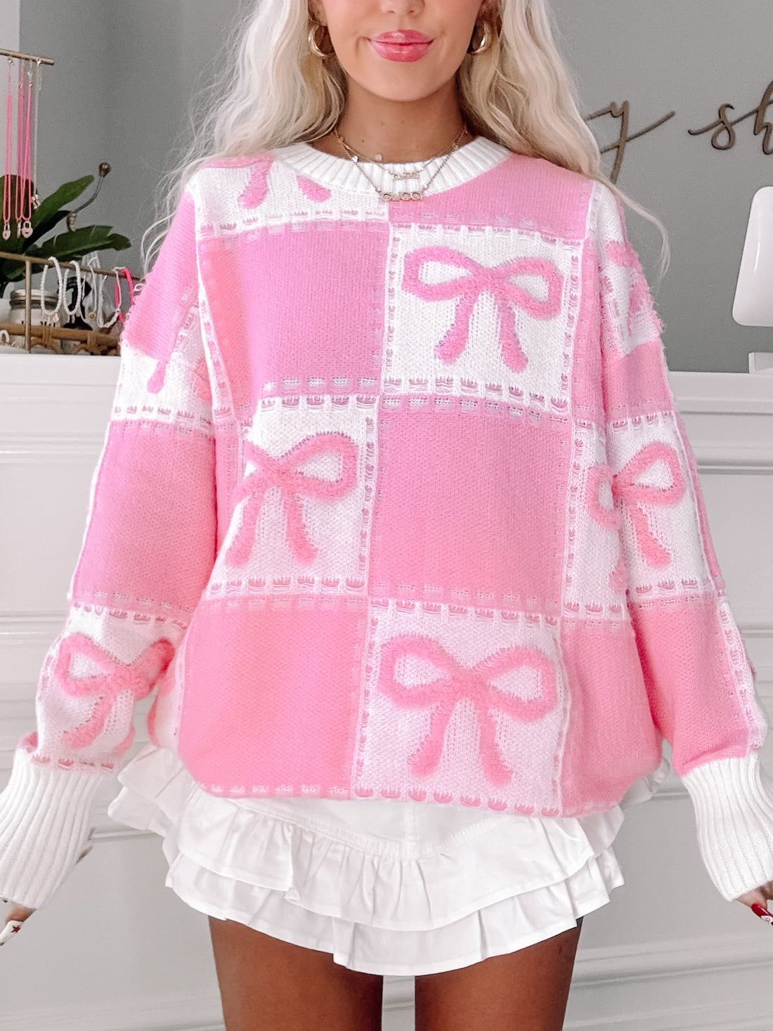 Pink Bow on Board sweater with white ribbed cuffs and bow details
