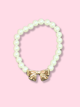 Elegant pearl bracelet with gold bow accent
