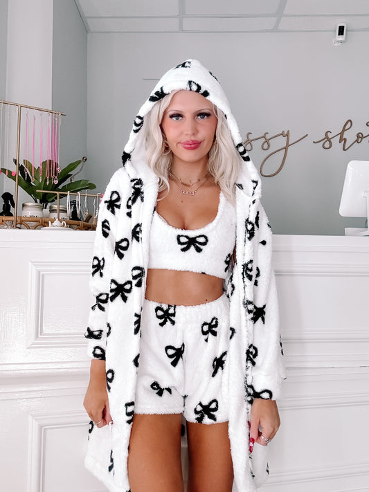 White hooded pajama set with black bow pattern; comfy and cozy lounge wear.