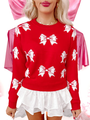 Red Brooklyn Bow Sweater with white bow pattern and ruffled hem.
