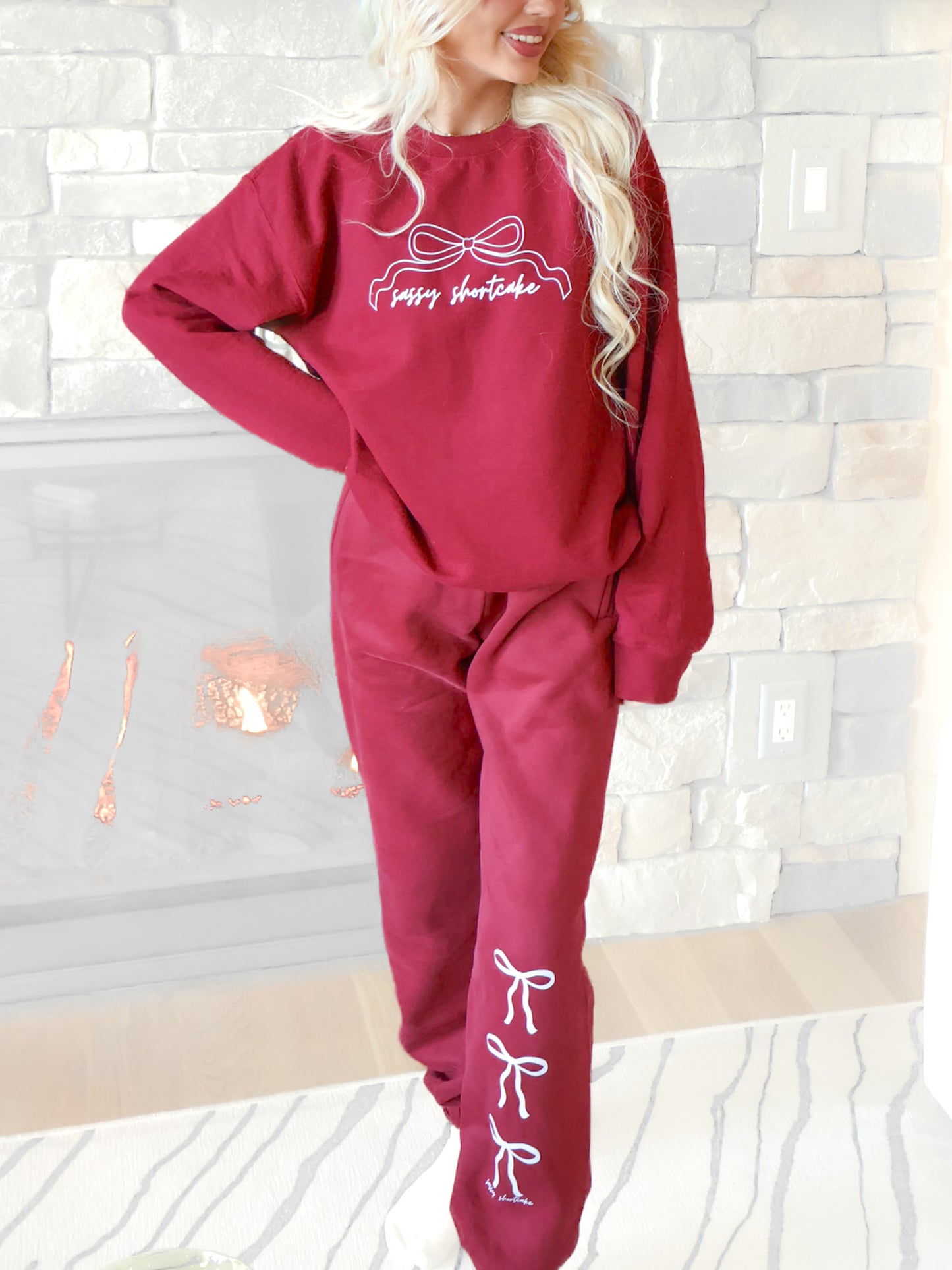 Sassy Shortcake Blushing Bow Sweatpants in burgundy, featuring three white bows and the "Sassy Shortcake" text.