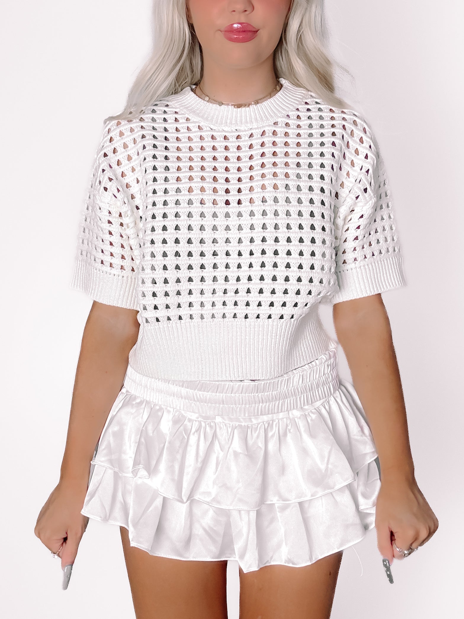 White Carson Crochet short-sleeve crop top with unique heart-shaped cutouts.
