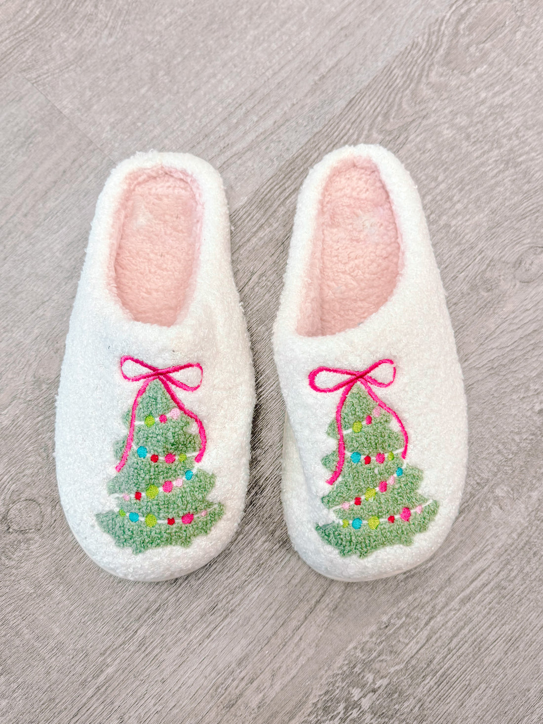 White Christmas tree slippers with pink lining, embroidered with a festive tree design | Sassy Shortcake
