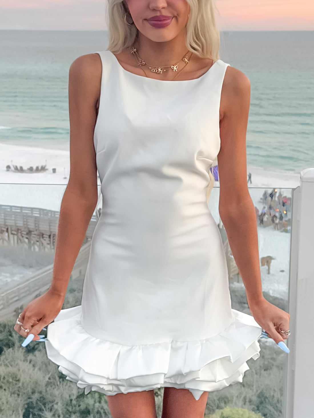 White Claire Cloud mini dress with ruffled hem, perfect for summer events.
