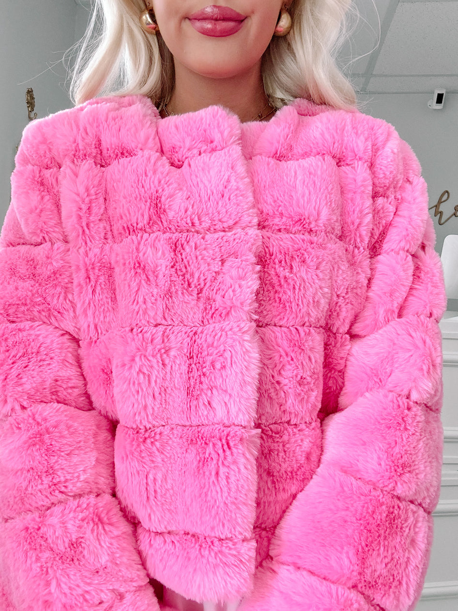 Pink faux fur cropped jacket with a quilted texture.
