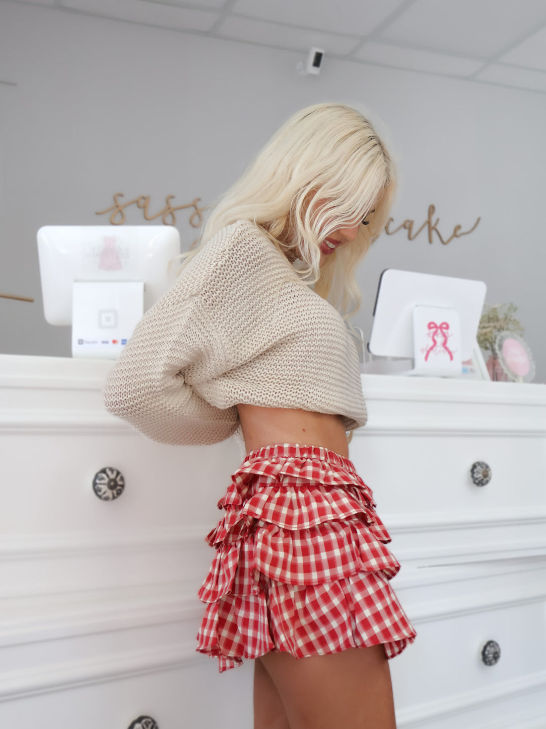 Side view of the Crimson Charm Skirt — reddish orange plaid ruffled mini with comfy stretch fit | Sassy Shortcake