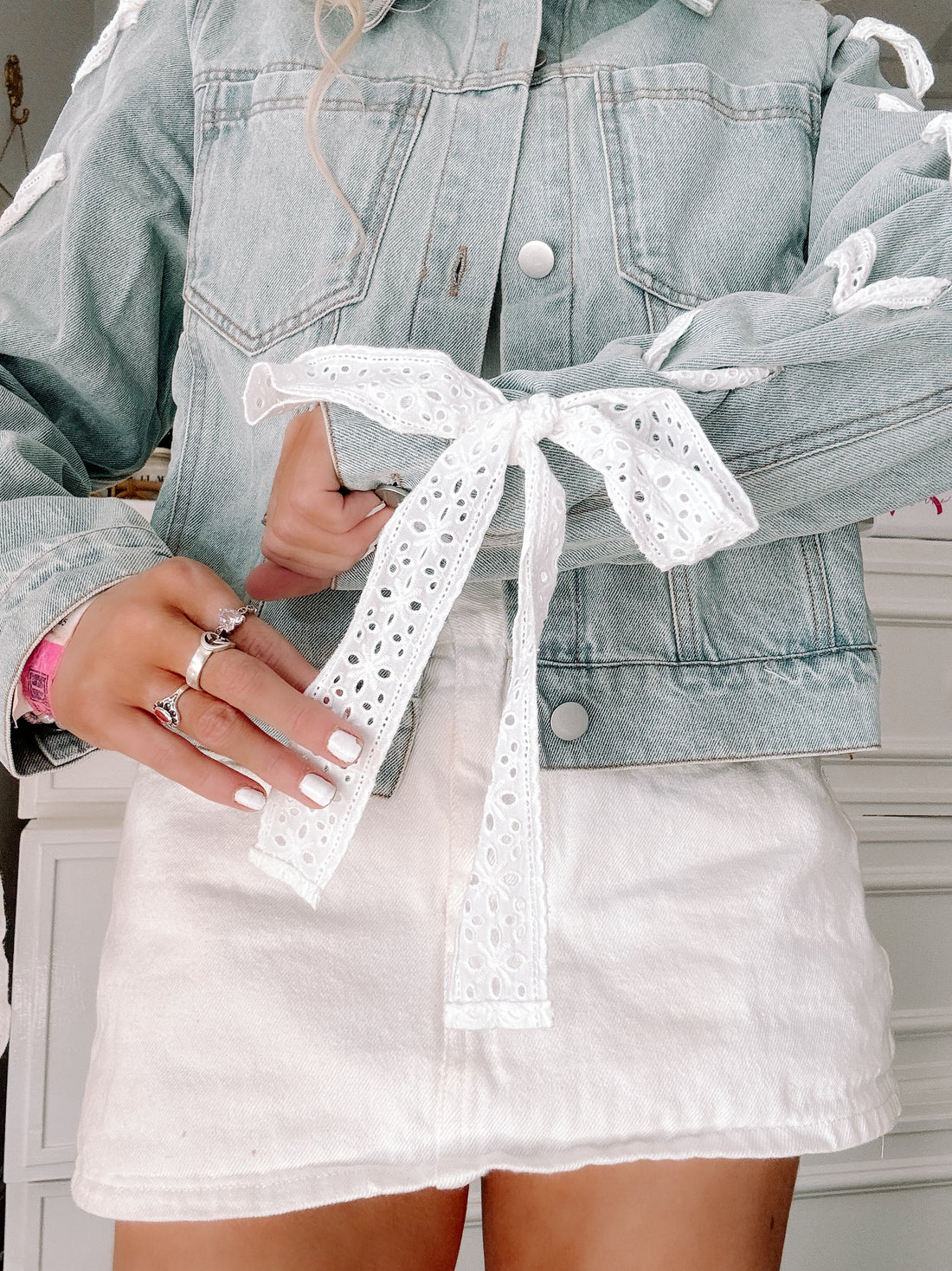 Sassy Shortcake Dainty Denim Jacket button-down with lace accents and pocket detail on model.