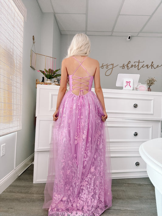 Side view of lilac strapless tulle maxi dress with layered skirt and soft flowing train from sassy shortcake