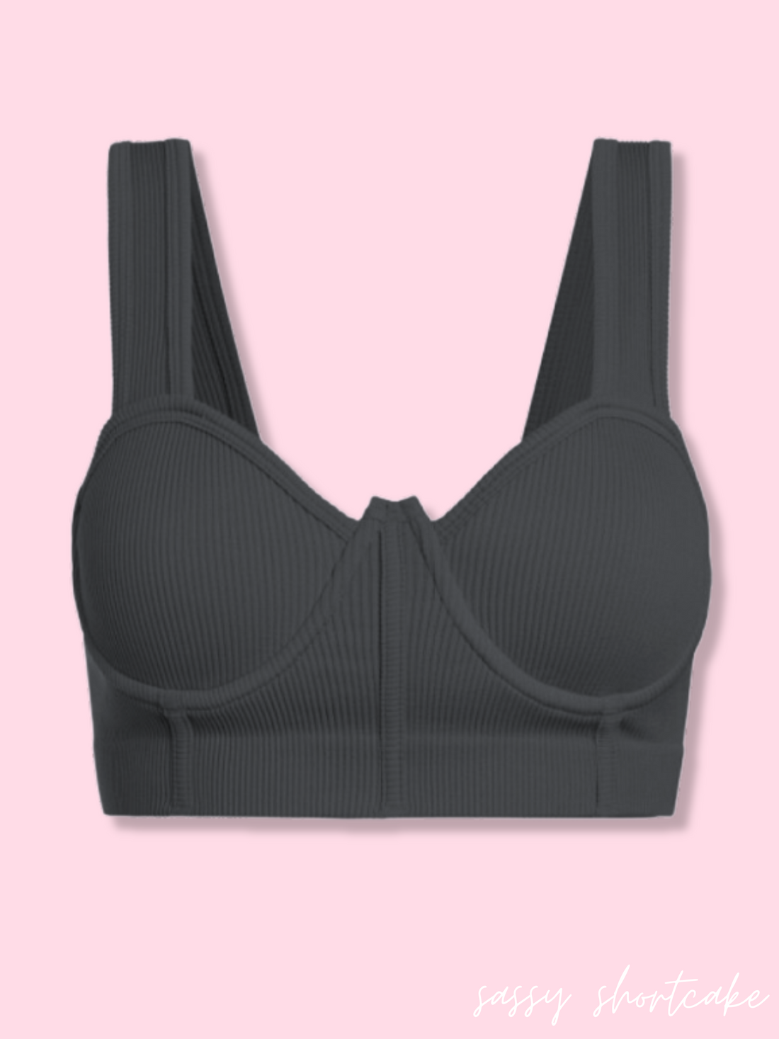Charcoal ribbed bra top against a pink background.
