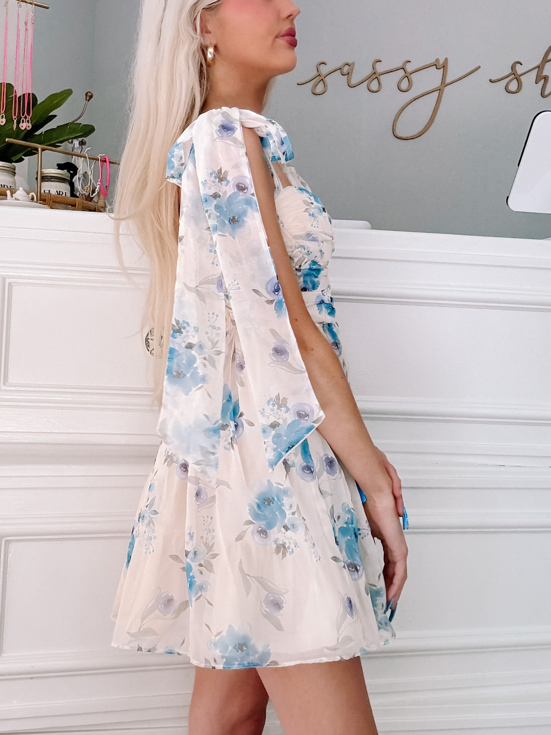 Floral mini dress; blue and white watercolor print, side view showcasing the bow straps.
