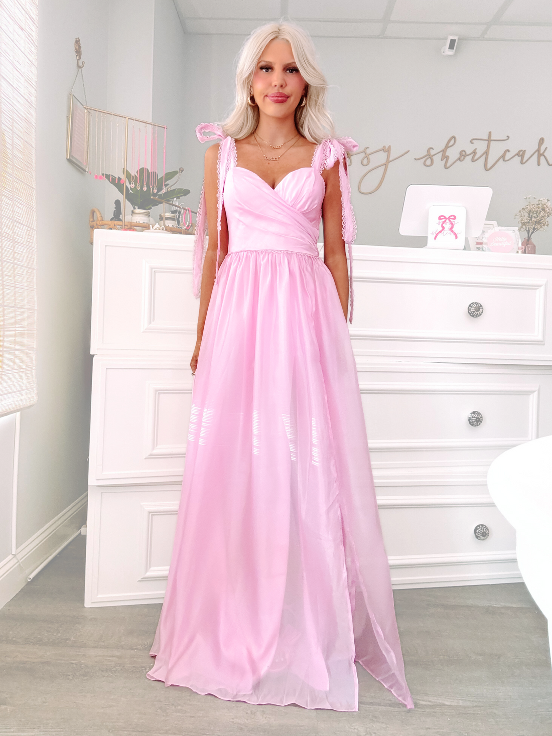 Model wearing a strapless blush pink tiered tulle mini dress with ruffle detail — perfect for bridal showers, birthdays, or girls’ night out