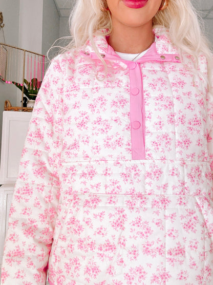 Floral Quilted Pullover from Sassy Shortcake - Person wearing a white floral pajama set with pink accents in a room.