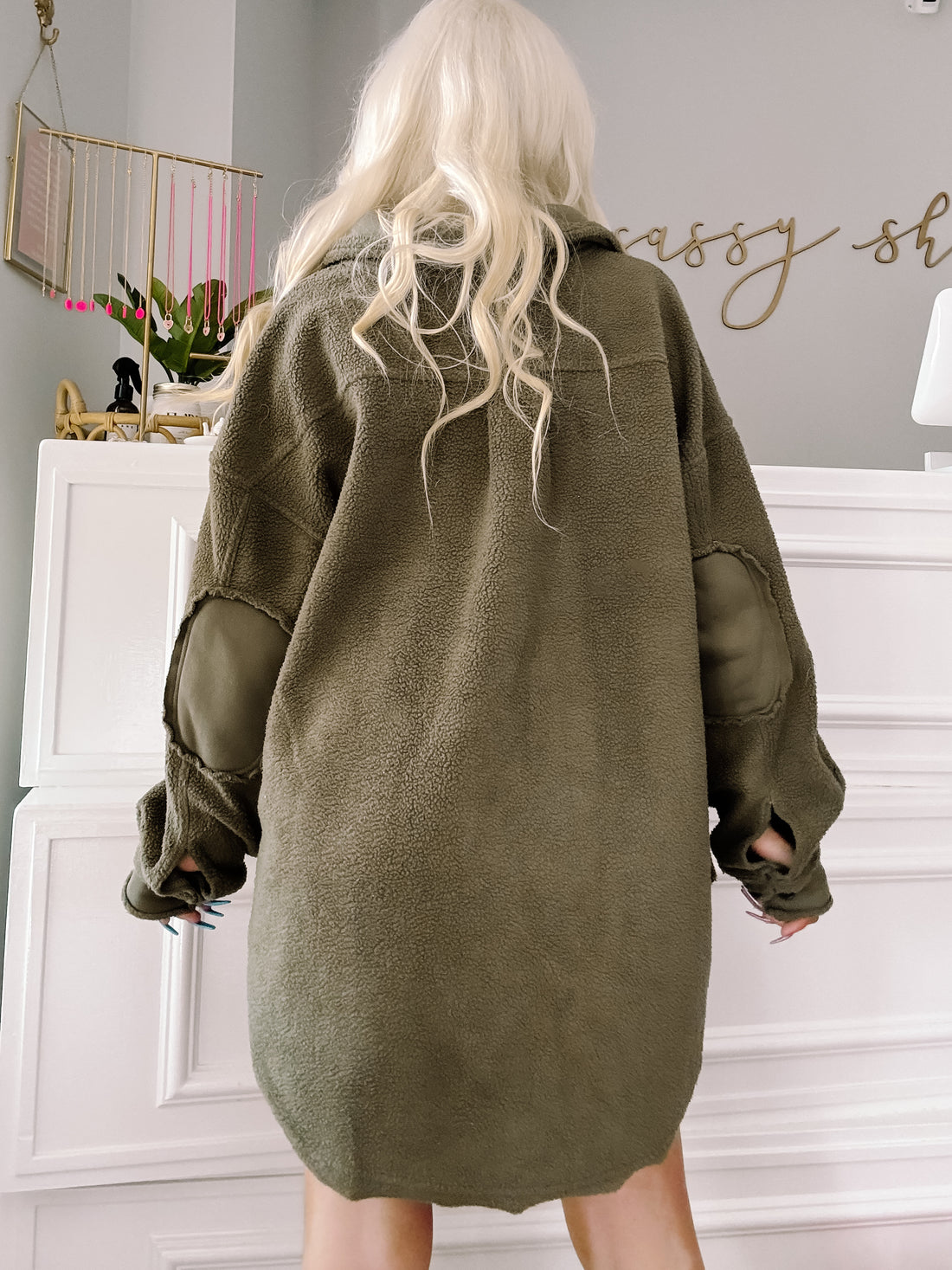 Olive green fleece shacket with elbow patches, shown from the back.

