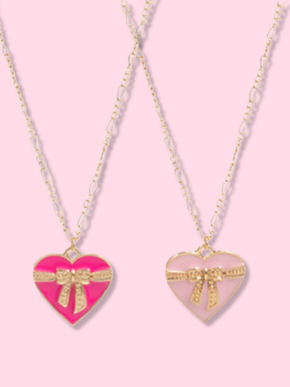 Gift of Love Necklace: Pink & blush heart pendant necklaces with gold bow accents, delicate gold chain.
