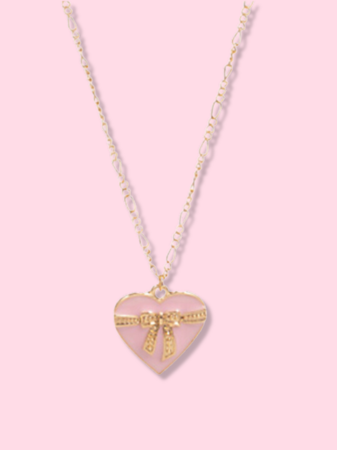 Gold chain necklace with a pink heart pendant adorned with a gold bow; lovely gift jewelry.
