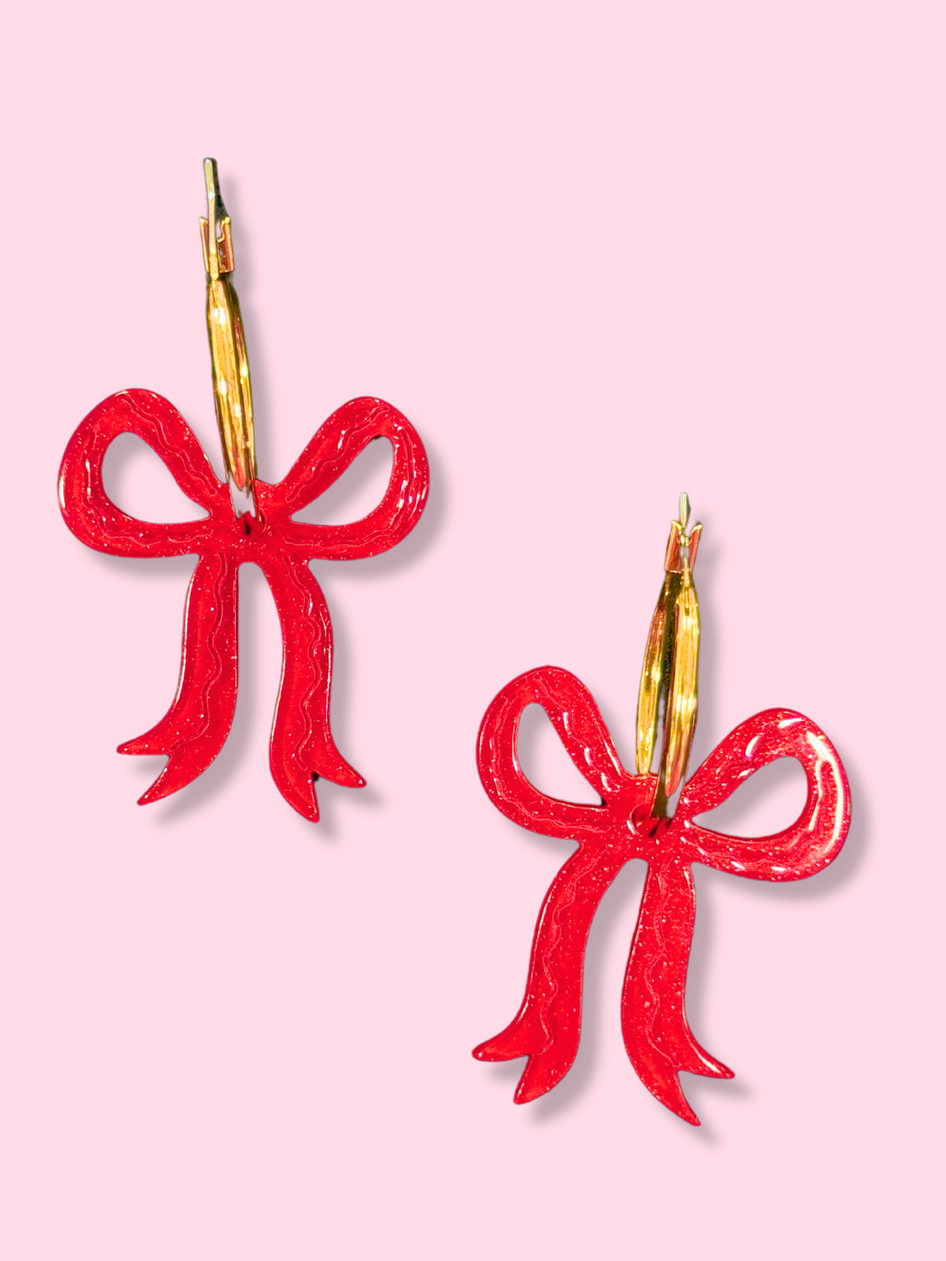 Red Glitter Bow Hoops earrings with gold hoops.
