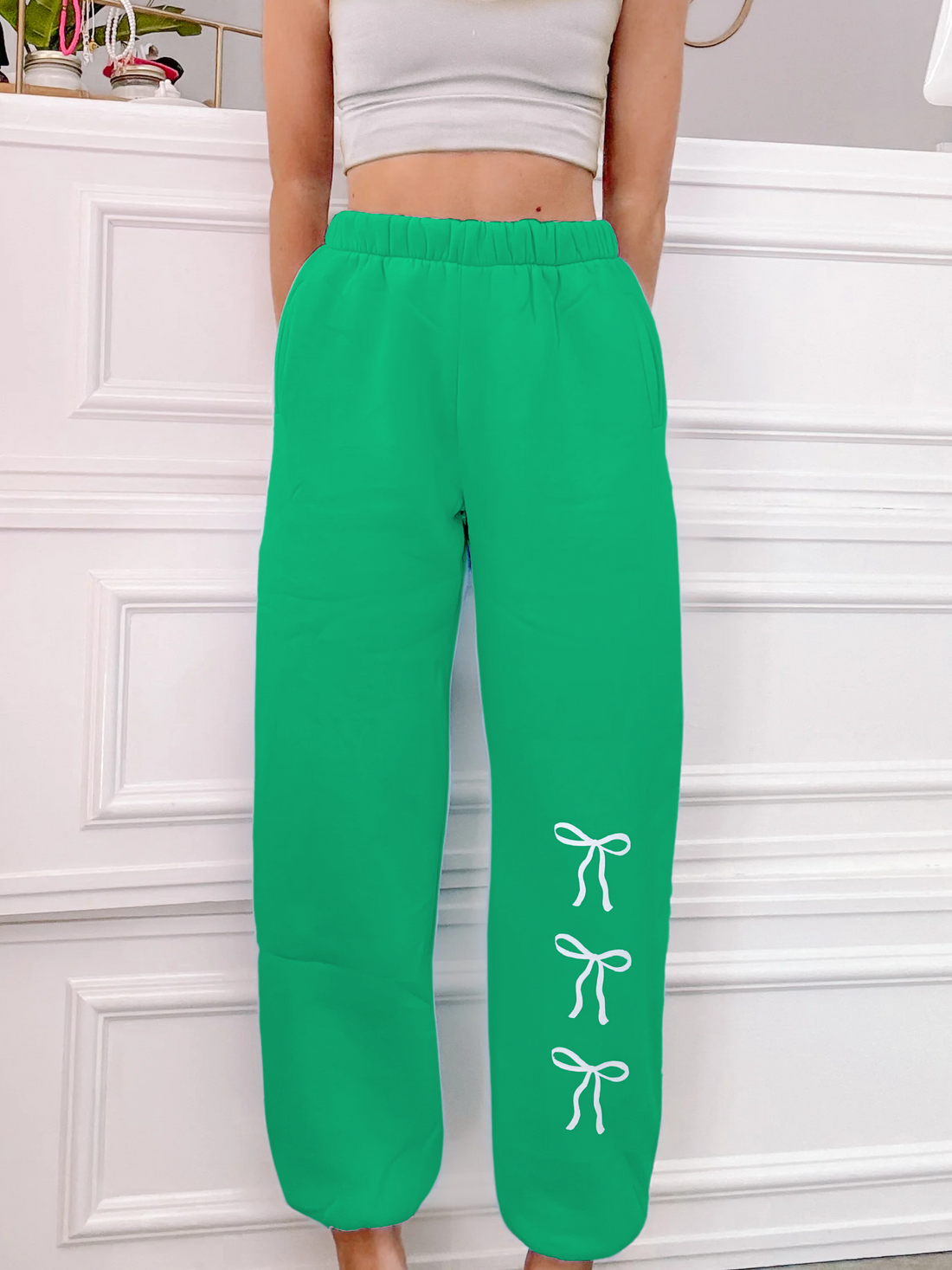 Green Blushing Bow sweatpants with white bow details.
