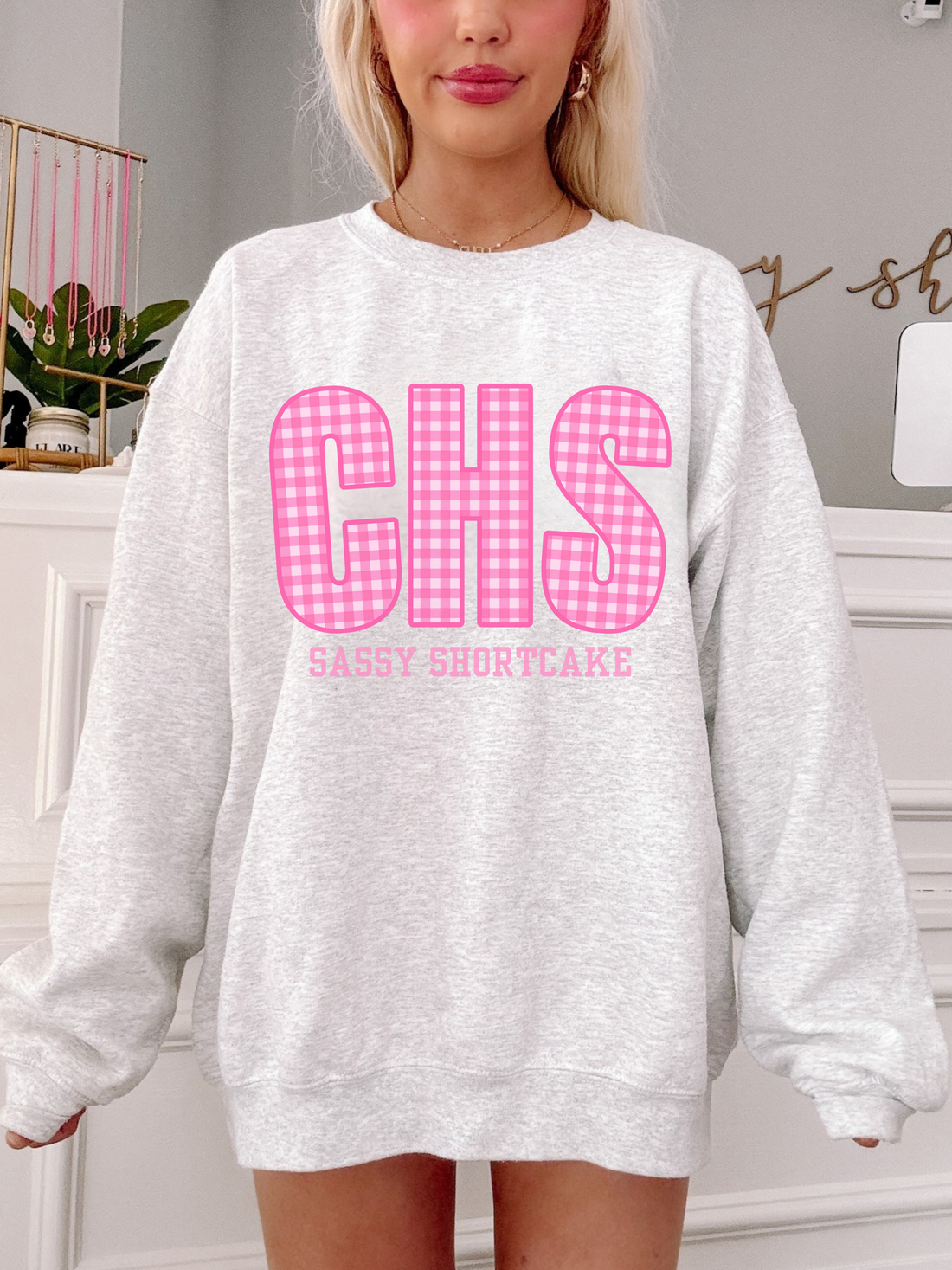 Grey oversized crewneck sweatshirt with pink gingham CHS Charleston graphic, preppy collegiate style by Sassy Shortcake – front view on model