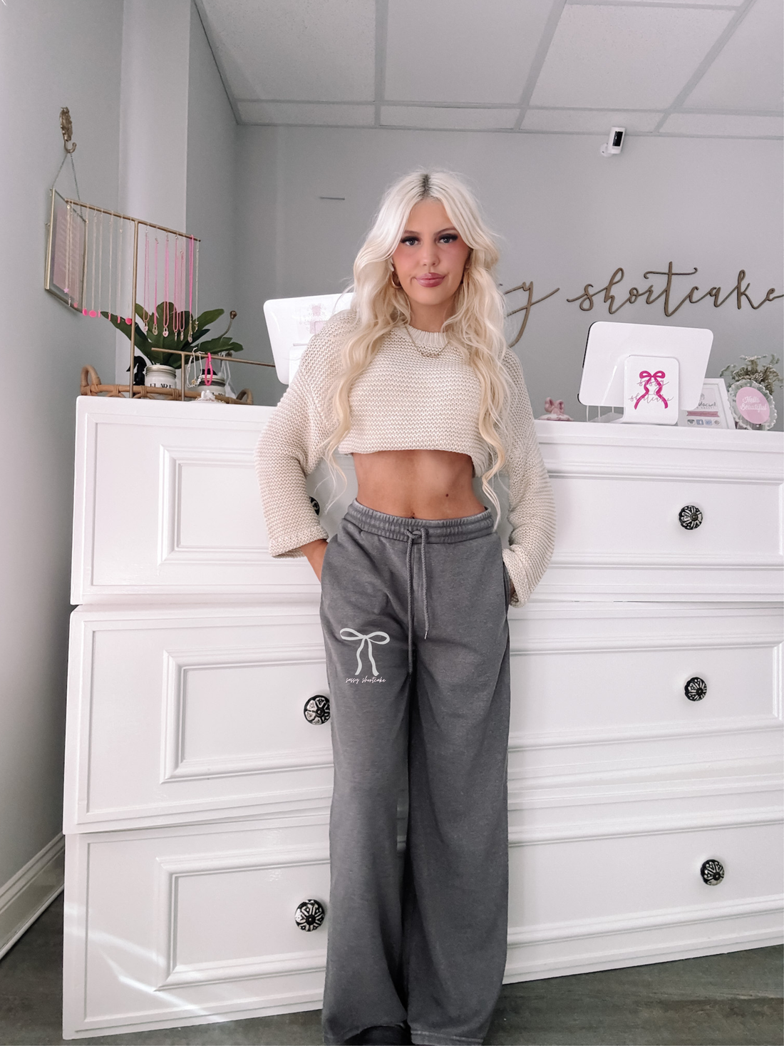 Front view of grey Sassy Bow Sweatpants featuring elastic waistband, pockets, and embroidered white bow logo | Sassy Shortcake