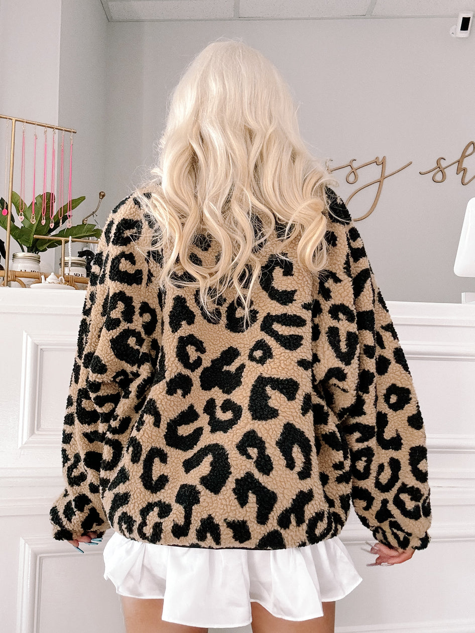 Tan and black leopard print sherpa jacket; cozy winter outerwear.
