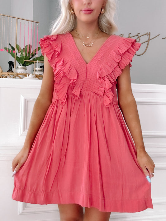 Coral pink mini dress with ruffled sleeves, pleated bodice, and V-neckline.