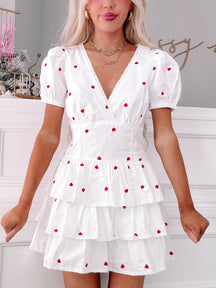 Hearts Desire Dress: White tiered mini dress with embroidered red hearts and lace trim.
