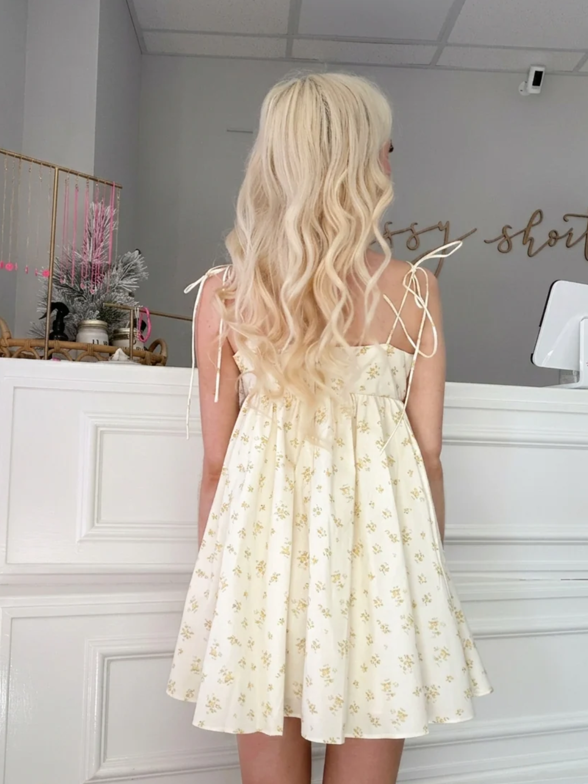 Rear view of Honey Floral Bowshine Dress by Sassy Shortcake showing tie-shoulder straps and mini length.