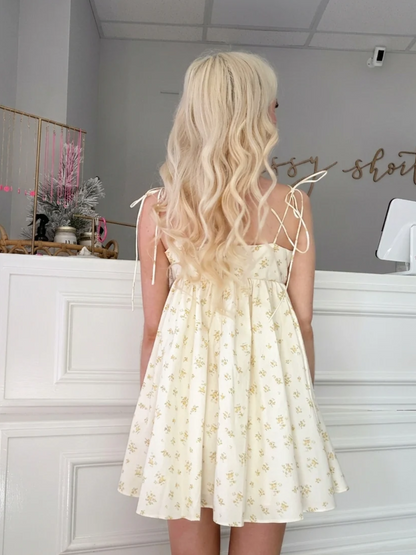 Rear view of Honey Floral Bowshine Dress by Sassy Shortcake showing tie-shoulder straps and mini length.